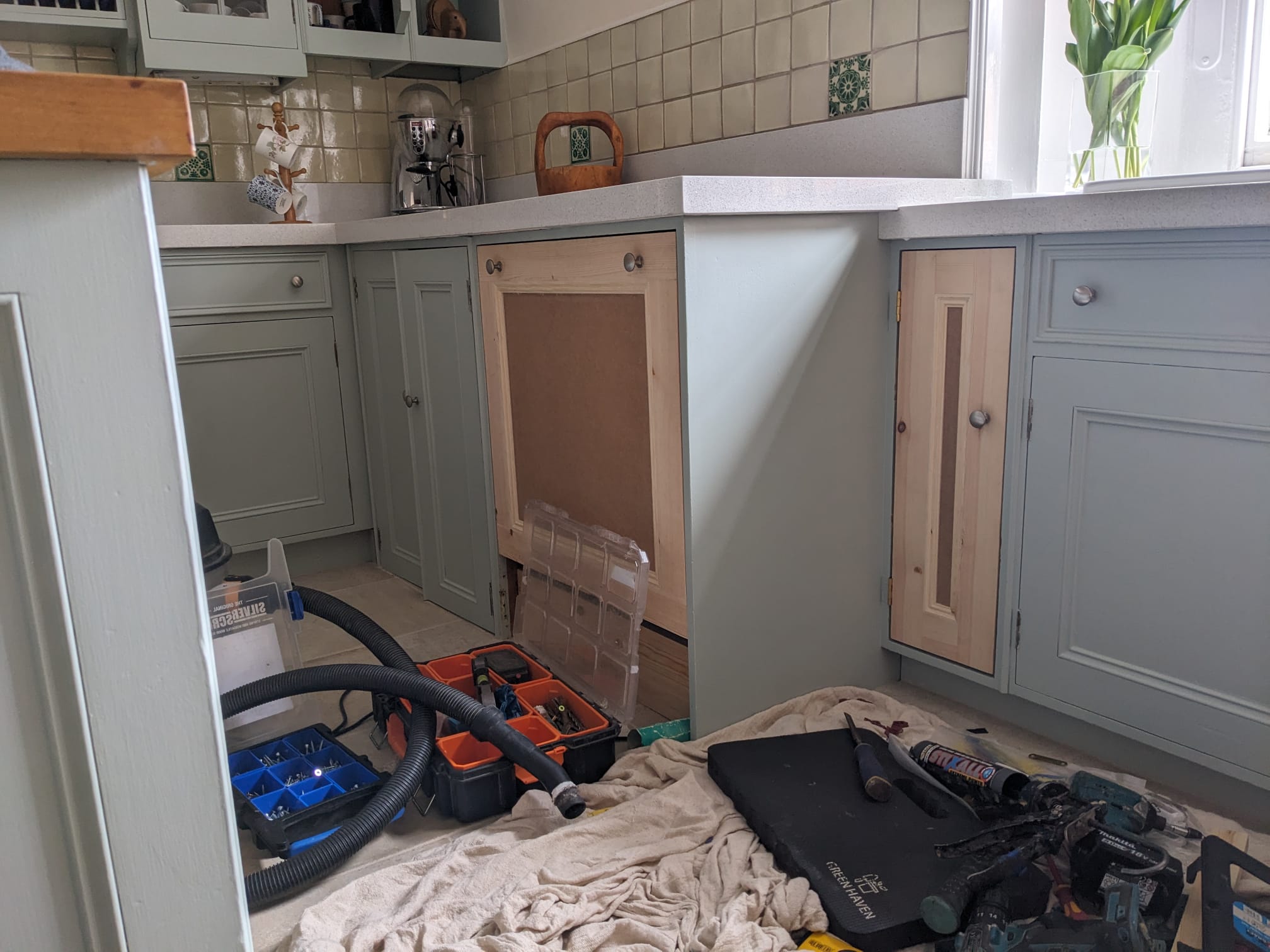 Handmade pine kitchen cabinet doors being fitted to match an existing painted kitchen